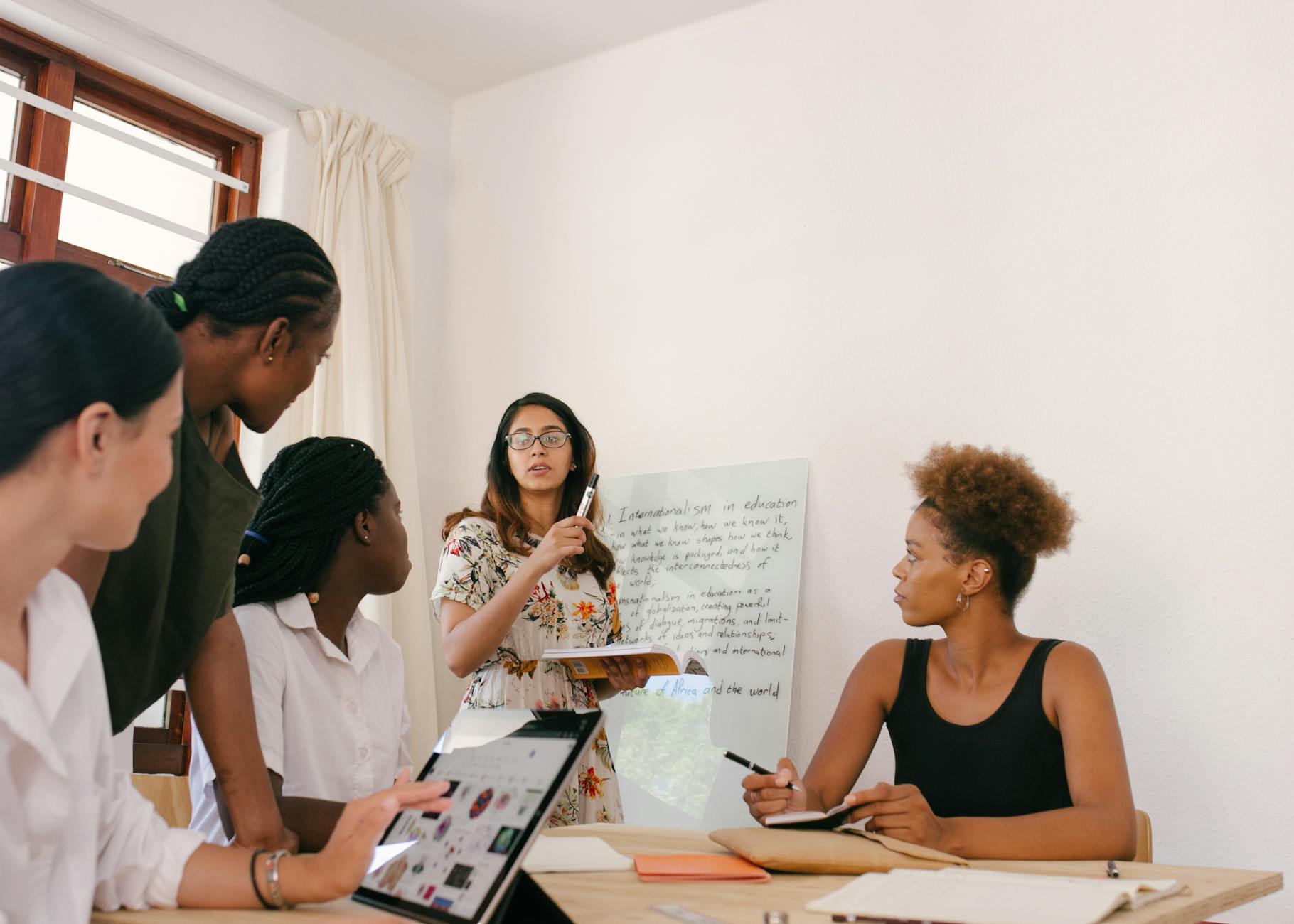 A diverse group of professionals collaborating in a modern office setting during a brainstorming session.